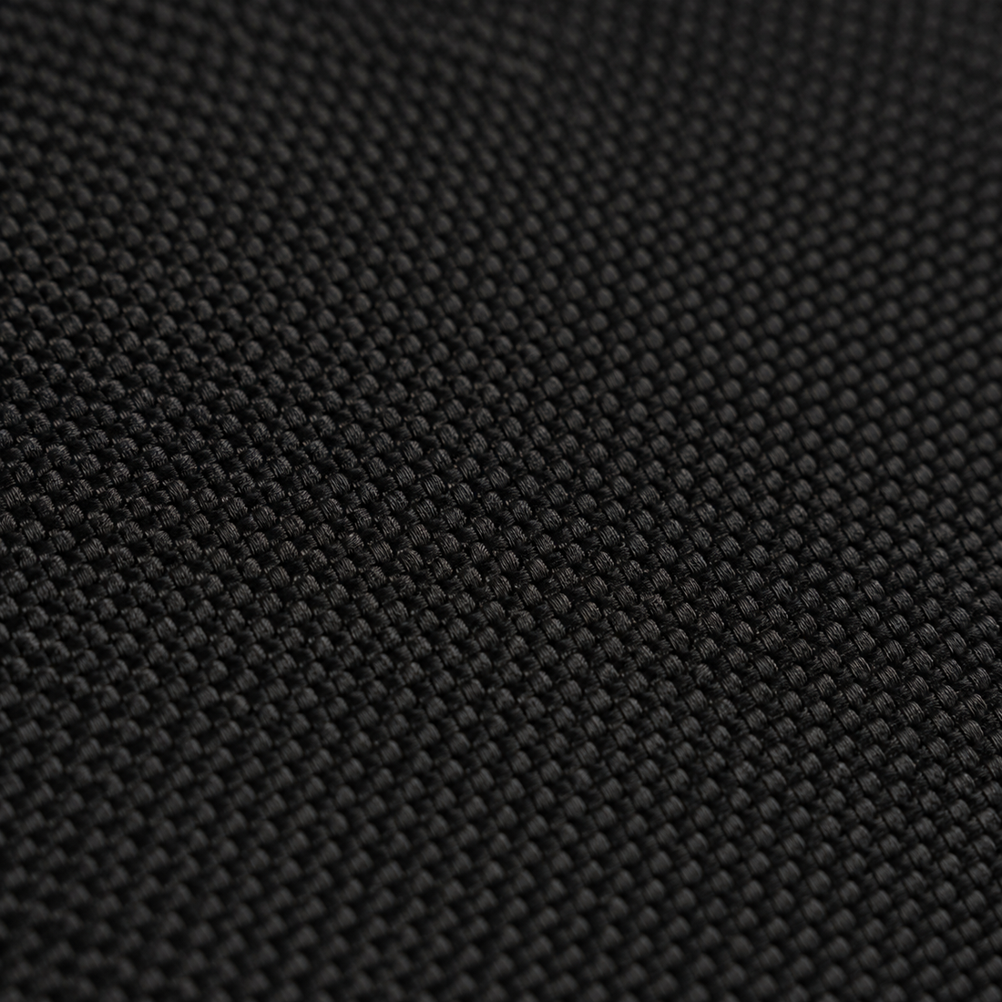 Close-up of the matte fine weave fabric top of the black Difavo Desk Mat