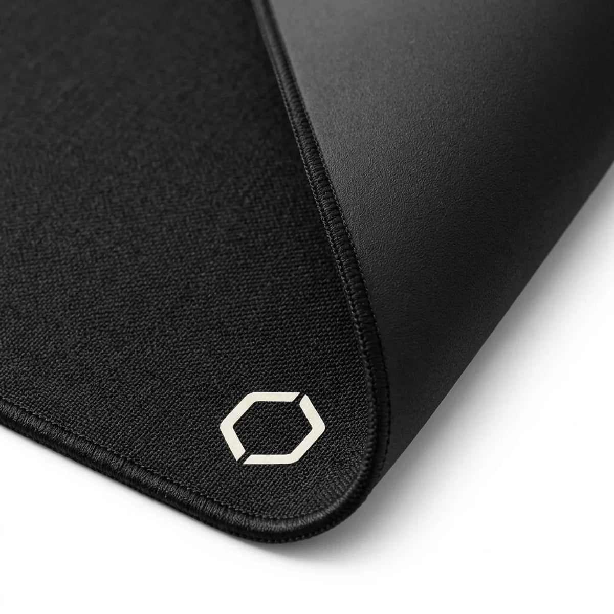 Corner of the Difavo Desk Mat showing the stitched edge and the Difavo mark