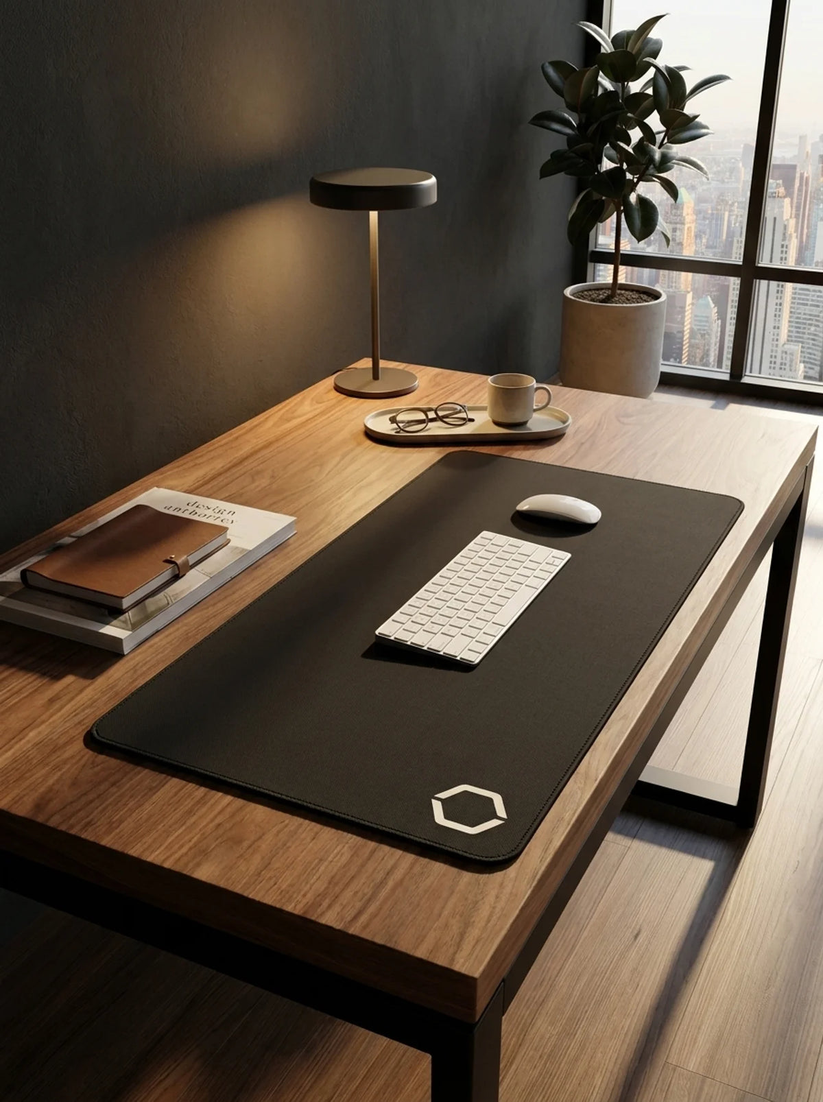 The Difavo Desk Mat on a warm wood executive desk beside a city window