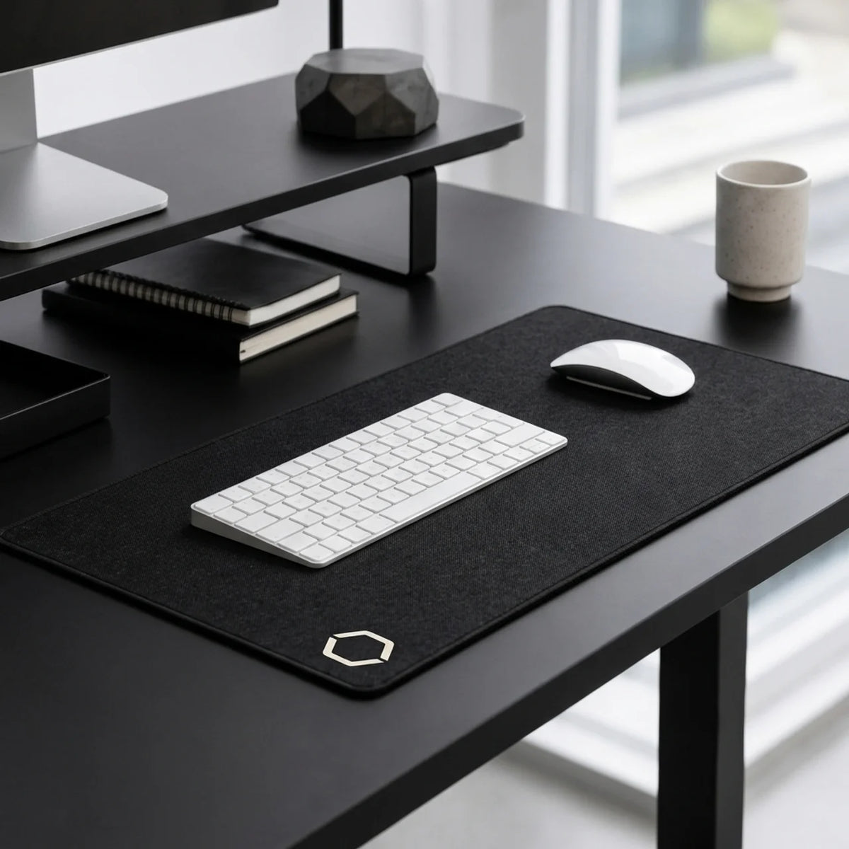 A quiet desk setup with the Difavo Desk Mat, keyboard, mouse and morning light