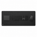 Top view of the black Difavo desk mat with keyboard, mouse and trackpad, showing the corner monogram logo