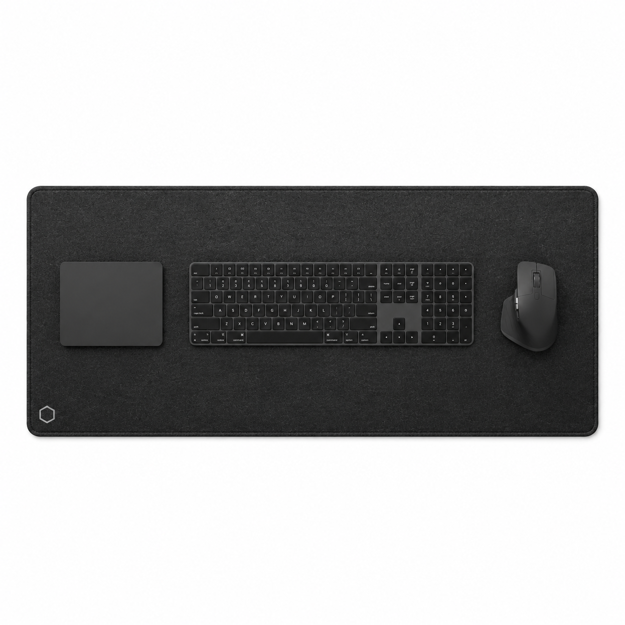 Top view of the black Difavo desk mat with keyboard, mouse and trackpad, showing the corner monogram logo